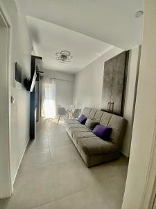 a living room with a couch and a table at Σουίτα Αλέξανδρος in Pefkochori
