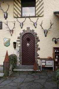 ein Gebäude mit einer braunen Tür mit Hirschköpfen drauf in der Unterkunft Jagdhaus Rech - Ahr in Rech
