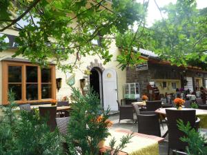 a patio of a restaurant with tables and chairs at Jagdhaus Rech - Ahr in Rech