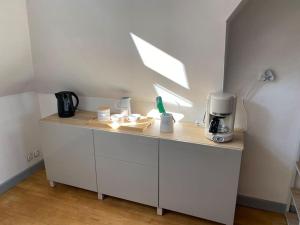 a kitchen with a counter with a coffee maker on it at Studio un cocon à la campagne in Saint-Samson-sur-Rance
