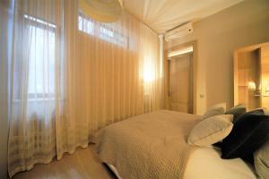 a bedroom with a large bed and a window at Oldtown apartment / New house + elevator in Rīga