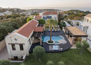 an aerial view of a house with a swimming pool at Peacock Villa in Daratso