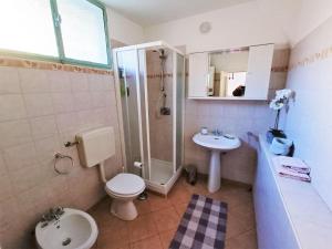 a bathroom with a toilet and a shower and a sink at Charming Home by Lake with Scenic Trails in Maccagno Inferiore