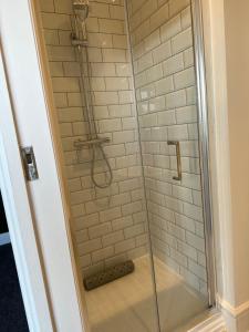 a shower with a glass shower stall in a bathroom at The Nags Head - Room only accommodation in Lyme Regis