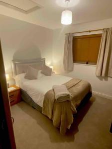 Schlafzimmer mit einem Bett und einem Fenster in der Unterkunft The Cart House - Staverton Cheltenham in Cheltenham