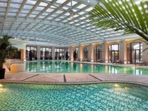 a large swimming pool in a building with a ceiling at Hotel Shanghai Sheshan Oriental - Handwritten Collection in Songjiang