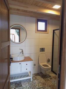 a bathroom with a sink and a toilet at Bellerofon villa in Cıralı