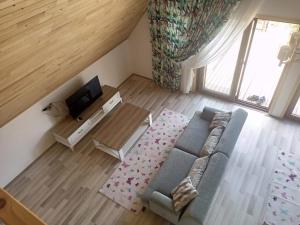 an overhead view of a living room with a couch and a tv at Bellerofon villa in Cıralı