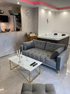 a living room with a blue couch and a table at Passion Airbnb in Strasbourg