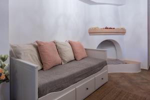 a couch with pillows on it in a room at Casa Aestas in Lachania