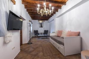 a bedroom with a bed and a tv and a ceiling at Casa Aestas in Lachania