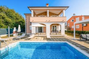 a villa with a swimming pool and a house at Villas Lotus with Pool and Jacuzzi in Pula