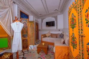 a living room with a dress hanging on the wall at Riad Fes Madaw in Fès