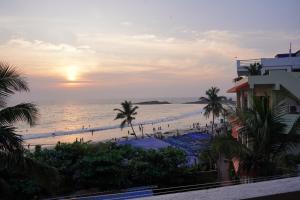 a view of the beach at sunset from a resort at Buddha Beach Hotel in Kovalam