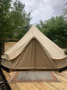 a canvas tent sitting on a wooden deck at Go Wild Glamping in Sibiu