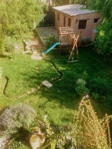 a yard with a playground with a slide at Los Amarantos in Tilcara