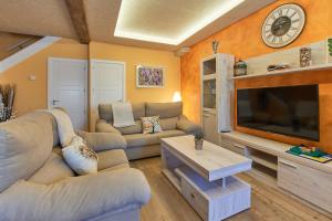 a living room with couches and a large television at Casa Dakar in Valdemaluque