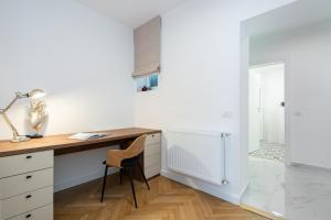 a kitchen with a desk with a lamp and a chair at Old Town Bucharest, Luxury 2 Bedrooms Apartment in Bucharest