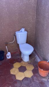 a bathroom with a toilet in a room at Zagora Desert Camp in Boikhlal