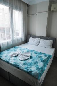 a bed with a blue blanket on top of it at Hotel Resat in Izmir +22 photos