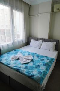 a bed with two towels sitting on top of it at Hotel Resat in Izmir