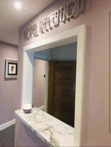 a large mirror in a room with a door at The Vine Hotel Chapel st Leonards in Skegness