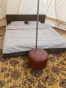 a bed with a mop on the floor next to a mattress at Go Wild Glamping in Sibiu