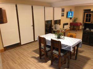 a dining room with a table and some cabinets at Santa Clara in San Carlos de Bariloche