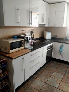 A kitchen or kitchenette at DUPLEX NOSY BE vue sur mer avec solarium et jacuzzi