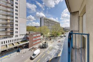 a view of a city street from a balcony at Le Casual- Clichy in Clichy