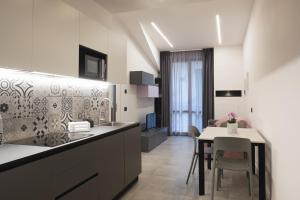 a kitchen with a table and a dining room at Amiata Suite in Abbadia San Salvatore