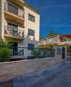 a building with a fence in front of it at Seven Seas Residence in Split