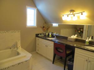 a bathroom with a sink and a bath tub and a sink at Wild Rose Bed & Breakfast in Saskatoon +33 photos