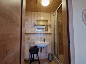 a bathroom with a sink and a shower at Gästehaus Kuchler in Lam