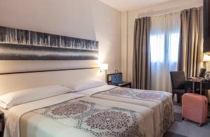 Postel nebo postele na pokoji v ubytování Hotel Macià Plaza