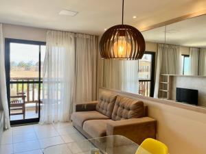 a living room with a couch and a glass table at VG Sun Cumbuco in Cumbuco