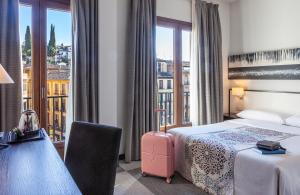 Postel nebo postele na pokoji v ubytování Hotel Macià Plaza