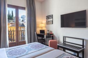 Postel nebo postele na pokoji v ubytování Hotel Macià Plaza