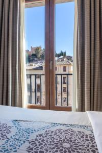 Postel nebo postele na pokoji v ubytování Hotel Macià Plaza