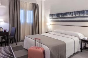 Postel nebo postele na pokoji v ubytování Hotel Macià Plaza