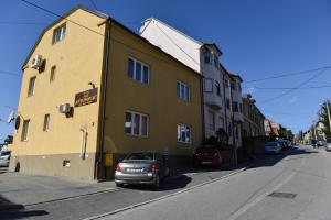 a yellow building on the side of a street at Villa Antunovac Zagreb in Zagreb