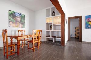 a dining room with a wooden table and chairs at Casa Vieja in Puerto del Rosario