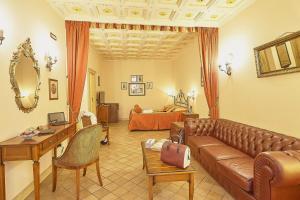 a living room with a couch and a table and a bed at Locanda del Gagini in Palermo