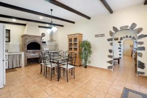 a dining room with a table and chairs and a fireplace at Casa Andrea in Tacoronte