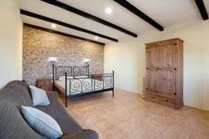 a bedroom with a bed and a wooden door at Casa Andrea in Tacoronte