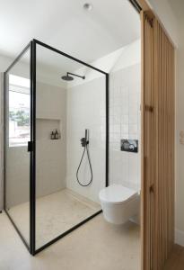 a bathroom with a shower and a toilet at Villa Sofia Cascais in Cascais