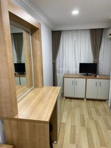 a room with a mirror and a desk and a television at Kafkas Hotel Istanbul in Istanbul