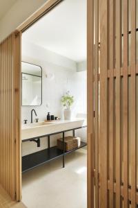 a bathroom with a sink and a mirror at Villa Sofia Cascais in Cascais