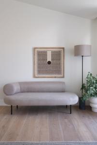 a couch in a living room with a lamp at Villa Sofia Cascais in Cascais