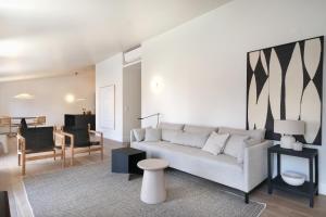 a living room with a couch and a table at Villa Sofia Cascais in Cascais